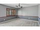 Empty bedroom with neutral carpet, two-tone gray walls, and a window with shutters at 2053 W Natal Cir, Mesa, AZ 85202