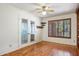 Empty bedroom with hardwood floors, ceiling fan, window and french doors at 2053 W Natal Cir, Mesa, AZ 85202