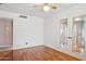 Empty bedroom with hardwood floors, ceiling fan, and french doors at 2053 W Natal Cir, Mesa, AZ 85202