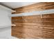 Walk in closet features custom wood and white shelving at 2053 W Natal Cir, Mesa, AZ 85202