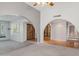 Open living room with archways, carpet, wood flooring, and unique architectural details at 2053 W Natal Cir, Mesa, AZ 85202