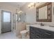 Updated bathroom with a glass shower, modern vanity, framed mirror, and tiled accents at 20809 N 17Th St, Phoenix, AZ 85024