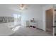 Bright bedroom with a ceiling fan, window, neutral carpet, and white shelves at 20809 N 17Th St, Phoenix, AZ 85024
