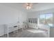 Bedroom with a large desk and ample storage, neutral carpet, bright window, and ceiling fan at 20809 N 17Th St, Phoenix, AZ 85024