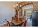 Elegant dining room with stone archway and a view to workout room at 20809 N 17Th St, Phoenix, AZ 85024