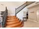 Elegant staircase with dark wood banister and light hardwood steps and tile flooring at 20809 N 17Th St, Phoenix, AZ 85024