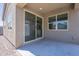 Back patio featuring a sliding glass door and windows, providing access to the backyard at 297 W Nikita Dr, San Tan Valley, AZ 85140