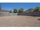 Spacious gravel backyard enclosed by a block wall, offering privacy and ample space at 297 W Nikita Dr, San Tan Valley, AZ 85140