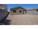Exterior view of the house featuring a backyard with gravel and a block wall fence at 297 W Nikita Dr, San Tan Valley, AZ 85140