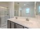 Bathroom featuring double sinks, sleek cabinets, and glass-enclosed shower at 297 W Nikita Dr, San Tan Valley, AZ 85140