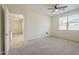 Bedroom featuring plush carpet, ceiling fan, and large window for natural light at 297 W Nikita Dr, San Tan Valley, AZ 85140