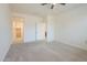 Bedroom featuring plush carpet, ceiling fan, and access to a large walk-in closet at 297 W Nikita Dr, San Tan Valley, AZ 85140