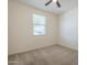 Simple carpeted bedroom featuring a ceiling fan and a window offering natural light at 297 W Nikita Dr, San Tan Valley, AZ 85140