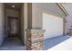 Welcoming front entrance highlighting a craftsman-style door and a two-car garage at 297 W Nikita Dr, San Tan Valley, AZ 85140