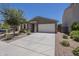 Lovely home featuring a well-manicured front yard, desert landscaping, and a two-car garage at 297 W Nikita Dr, San Tan Valley, AZ 85140