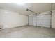 Spacious two-car garage with concrete floor and a standard garage door at 297 W Nikita Dr, San Tan Valley, AZ 85140