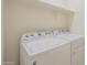 Laundry room with a full-size, white washing machine and dryer at 297 W Nikita Dr, San Tan Valley, AZ 85140