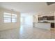 Open-concept living space with neutral tile, bright natural light, and kitchen view at 297 W Nikita Dr, San Tan Valley, AZ 85140