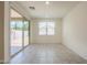 Bright living room featuring ceramic tile floors and sliding glass doors to backyard patio at 297 W Nikita Dr, San Tan Valley, AZ 85140