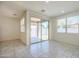 Bright living room featuring ceramic tile floors and sliding glass doors to backyard patio at 297 W Nikita Dr, San Tan Valley, AZ 85140