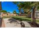 The backyard features a lush lawn, mature trees, a storage shed and a swing set at 3343 W Lone Cacuts Dr, Phoenix, AZ 85027
