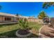 Expansive backyard with a well-maintained lawn, storage shed, swing set, and mature trees at 3343 W Lone Cacuts Dr, Phoenix, AZ 85027