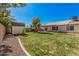 Spacious backyard with green grass, a shed, and a patio area, great for outdoor activities at 3343 W Lone Cacuts Dr, Phoenix, AZ 85027