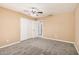 A bedroom features carpet, ceiling fan, and a doorway to the en suite bathroom at 3343 W Lone Cacuts Dr, Phoenix, AZ 85027