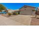 Single-story home featuring a spacious driveway, desert landscaping, and two-car garage at 3343 W Lone Cacuts Dr, Phoenix, AZ 85027