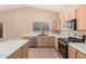 Modern kitchen with stainless steel appliances, light wood cabinets, and tile floors at 3343 W Lone Cacuts Dr, Phoenix, AZ 85027