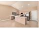 Bright kitchen with stainless steel appliances, light wood cabinets, and a kitchen island at 3343 W Lone Cacuts Dr, Phoenix, AZ 85027