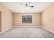 A spacious main bedroom features neutral walls, plush carpet, and a bright window at 3343 W Lone Cacuts Dr, Phoenix, AZ 85027