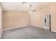 A large, carpeted main bedroom with neutral paint and adjacent entryways at 3343 W Lone Cacuts Dr, Phoenix, AZ 85027