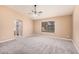 Bright main bedroom with neutral tones, ceiling fan, and access to ensuite bathroom at 3343 W Lone Cacuts Dr, Phoenix, AZ 85027