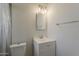 Bathroom featuring a single sink vanity, a toilet, and a shower with a plastic curtain at 3347 W Roma Ave, Phoenix, AZ 85017