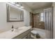 Bathroom featuring a single sink vanity and a shower over a tub with tile backsplash at 3347 W Roma Ave, Phoenix, AZ 85017