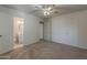 Bedroom featuring neutral carpet, ceiling fan, and an ensuite bathroom with a modern vanity and toilet at 3347 W Roma Ave, Phoenix, AZ 85017