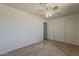 Bedroom featuring neutral carpet, ceiling fan, and an empty closet for ample storage at 3347 W Roma Ave, Phoenix, AZ 85017