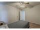 Bedroom featuring a ceiling fan with lights, a bed and a doorway to another room at 3347 W Roma Ave, Phoenix, AZ 85017