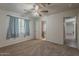 Bright bedroom featuring neutral carpet, a ceiling fan, and an ensuite bathroom with a shower at 3347 W Roma Ave, Phoenix, AZ 85017