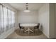 Bright breakfast nook with a modern light fixture, tile flooring, and a window with drapes at 3347 W Roma Ave, Phoenix, AZ 85017