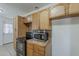 Kitchen features tile countertops, wood cabinets, oven, and stainless steel microwave at 3347 W Roma Ave, Phoenix, AZ 85017