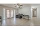 Bright living room boasts tile flooring, ceiling fan, and access to the outdoor patio at 3347 W Roma Ave, Phoenix, AZ 85017
