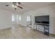 Bright living room with tiled floors and ceiling fan at 3347 W Roma Ave, Phoenix, AZ 85017