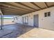 Covered patio featuring a concrete floor, painted wood support beams and a doorway at 3347 W Roma Ave, Phoenix, AZ 85017