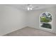 Bedroom with neutral carpet features a ceiling fan and a view of the backyard at 3514 W Helena Dr, Glendale, AZ 85308
