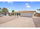 Charming single-story home featuring arched windows, a two-car garage, and low-maintenance desert landscaping at 3514 W Helena Dr, Glendale, AZ 85308
