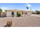 A picturesque single-story home featuring desert landscaping, arched windows, and an attached garage at 3514 W Helena Dr, Glendale, AZ 85308