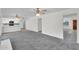 Large living room area showcasing new carpet, light walls, and an eat-in kitchen at 3514 W Helena Dr, Glendale, AZ 85308