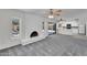 Inviting living space with a painted brick fireplace and access to the kitchen and backyard at 3514 W Helena Dr, Glendale, AZ 85308